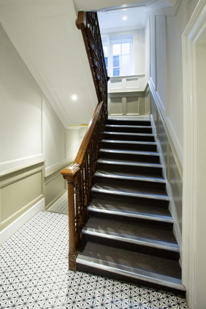 The original carved-wood staircase inside the building